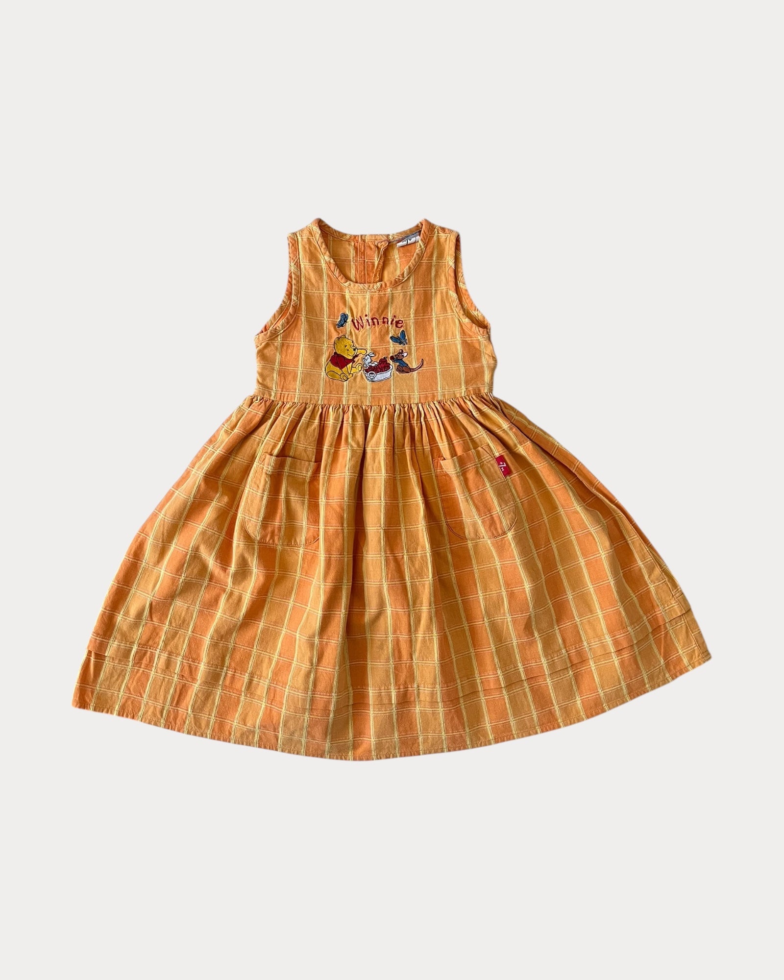 Vintage Winnie The Pooh dress features a soft orange/yellow 